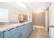Modern bathroom with granite countertop double vanity and a large walk-in shower at 1355 Pacific Rd, Kissimmee, FL 34759