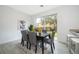 Dining area with dark wood table and gray chairs, view of backyard at 1355 Pacific Rd, Kissimmee, FL 34759
