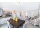 Open concept dining room with dark wood table and gray chairs at 1355 Pacific Rd, Kissimmee, FL 34759