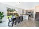 Bright kitchen and dining area with gray cabinets, stainless steel appliances, and sliding glass doors to backyard at 1355 Pacific Rd, Kissimmee, FL 34759