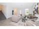 Spacious living room with beige sofa and two armchairs at 1355 Pacific Rd, Kissimmee, FL 34759