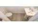Convenient powder room with pedestal sink and wood-look tile floor at 1355 Pacific Rd, Kissimmee, FL 34759