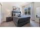 Cozy bedroom with a comfortable bed, nightstands and large window at 17114 Blessing Dr, Clermont, FL 34714