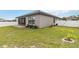 Spacious backyard with grassy lawn and screened patio at 1880 Goblet Cove St, Kissimmee, FL 34746