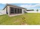 Expansive grassy backyard with screened patio and privacy fence at 1880 Goblet Cove St, Kissimmee, FL 34746