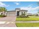 One-story home with a two-car garage and nicely manicured lawn at 1880 Goblet Cove St, Kissimmee, FL 34746