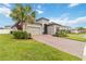 Single-story house with brick driveway and lush landscaping at 1880 Goblet Cove St, Kissimmee, FL 34746