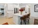 Modern kitchen with white cabinets, stainless steel appliances, and an island with seating at 1880 Goblet Cove St, Kissimmee, FL 34746