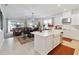 Open concept kitchen with island, stainless steel appliances, and view into living area at 1880 Goblet Cove St, Kissimmee, FL 34746