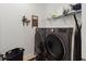 Laundry room with washer, dryer, and shelving for storage at 1880 Goblet Cove St, Kissimmee, FL 34746