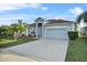 House exterior with gray siding, brown roof, and a two-car garage at 24 Altera Ct, Kissimmee, FL 34758