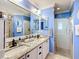 Bright bathroom with dual vanity, walk-in shower, and granite countertops at 2494 Five Forks Trl, The Villages, FL 32162