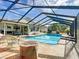 Inviting screened pool area with spacious patio and lush landscaping at 2494 Five Forks Trl, The Villages, FL 32162