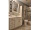 Clean bathroom with white cabinets and a shower/tub combo at 2606 Royal Fern Pl, Kissimmee, FL 34758