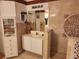 Bathroom with a sink, decorative tile and built-in cabinet at 2606 Royal Fern Pl, Kissimmee, FL 34758
