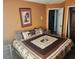 King-size bed in spacious bedroom with wood floors at 2606 Royal Fern Pl, Kissimmee, FL 34758