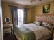Bedroom with queen bed and a window with curtains at 2606 Royal Fern Pl, Kissimmee, FL 34758