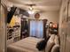 Bright bedroom featuring a queen bed and built-in shelving at 2606 Royal Fern Pl, Kissimmee, FL 34758