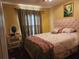 Bedroom with queen bed and a window with curtains at 2606 Royal Fern Pl, Kissimmee, FL 34758