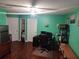 Home office with hardwood floors and built-in shelving at 2606 Royal Fern Pl, Kissimmee, FL 34758
