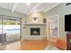 Living room with fireplace, pool view, and hardwood floors at 279 Tigerlily Ct, Altamonte Springs, FL 32714