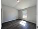 Spacious bedroom with grey wood-look flooring and window at 297 Oak Lane Way, Ocala, FL 34472