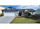 Gray house with white garage door and landscaped yard at 552 Brentford Ct, Kissimmee, FL 34758