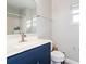 Updated bathroom with a navy blue vanity and a white toilet at 557 Dove Ct, Kissimmee, FL 34759