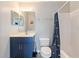 Bathroom with navy vanity, shower/tub, and updated fixtures at 557 Dove Ct, Kissimmee, FL 34759