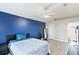 Main bedroom with a blue accent wall and wood-look floors at 557 Dove Ct, Kissimmee, FL 34759
