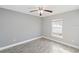 Well-lit bedroom featuring wood-look floors and a ceiling fan at 557 Dove Ct, Kissimmee, FL 34759