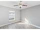 Spacious bedroom with wood-look floors and ceiling fan at 557 Dove Ct, Kissimmee, FL 34759