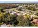 Aerial view of a residential neighborhood with houses and trees at 607 Tamarin Ln, Kissimmee, FL 34759