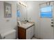 Bathroom with sink, toilet, and linen storage at 607 Tamarin Ln, Kissimmee, FL 34759