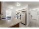 Kitchen features white cabinets, stainless steel appliances, and view to dining area at 607 Tamarin Ln, Kissimmee, FL 34759