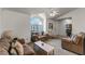 Living room featuring neutral colored sofas and a large arched window at 607 Tamarin Ln, Kissimmee, FL 34759