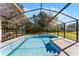 Refreshing swimming pool with screened enclosure at 607 Tamarin Ln, Kissimmee, FL 34759