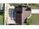 Overhead view of a house with a screened-in pool and a paved patio at 644 Bent Oak Loop, Davenport, FL 33837