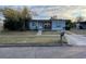 Cute bungalow style home with a well-maintained lawn and updated exterior at 7024 Moderna Way, Orlando, FL 32822