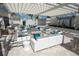 Outdoor seating area with white furniture under a pergola at 9182 Sonoma Coast Dr, Winter Garden, FL 34787