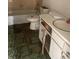 Bathroom needing renovation with toilet and sink at 1105 Valencia Ave, Haines City, FL 33844