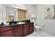 Bathroom with dark wood vanity, toilet and walk-in shower at 1301 Tuscan Ter # 9107, Davenport, FL 33896