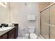 Bathroom with dark vanity, toilet and large shower at 1301 Tuscan Ter # 9107, Davenport, FL 33896