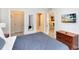 Bedroom with dark blue bedding, dresser and walk-in closet at 1301 Tuscan Ter # 9107, Davenport, FL 33896