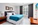 Spacious bedroom with teal bedding and large window at 1301 Tuscan Ter # 9107, Davenport, FL 33896