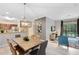 Modern dining area with wood table and six chairs, open to kitchen at 1301 Tuscan Ter # 9107, Davenport, FL 33896