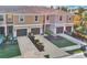 Aerial view of townhouses with brown garages and surrounding landscape at 1336 Chelsea Dr, Davenport, FL 33897