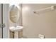 Small bathroom with pedestal sink and oval mirror at 1336 Chelsea Dr, Davenport, FL 33897