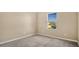 Simple carpeted bedroom with a window at 1336 Chelsea Dr, Davenport, FL 33897