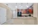 Modern kitchen with dark wood cabinets, granite counters, and black appliances at 1336 Chelsea Dr, Davenport, FL 33897